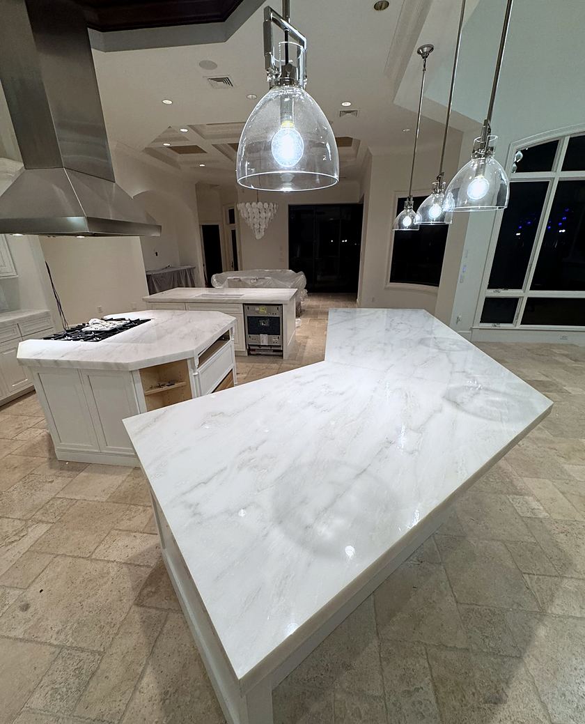 Kitchen island in marble with stainless hood