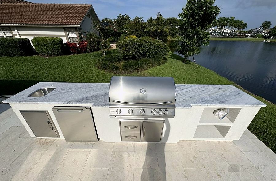 Outdoor kitchen with stone countertop by the water