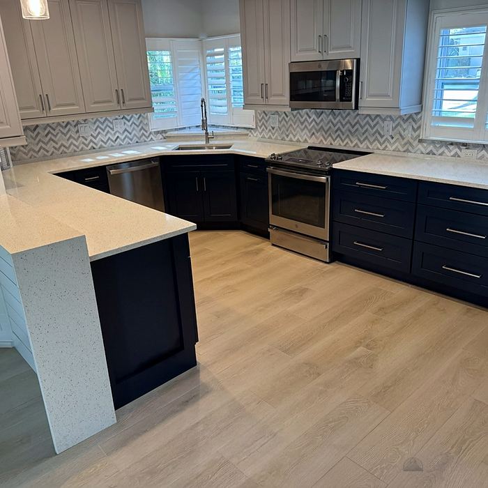 Kitchen with navy cabinets and stone countertops