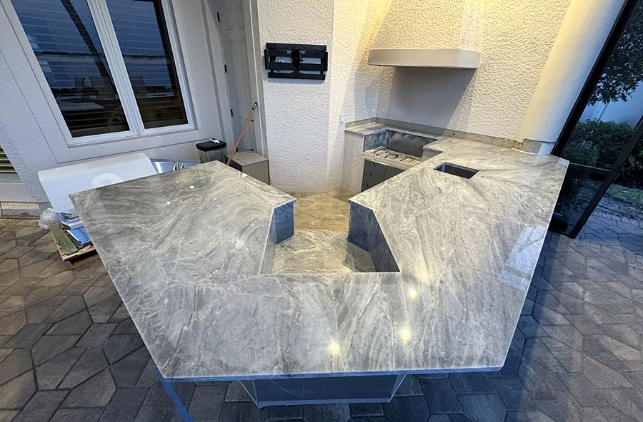 Large outdoor kitchen with stone countertops