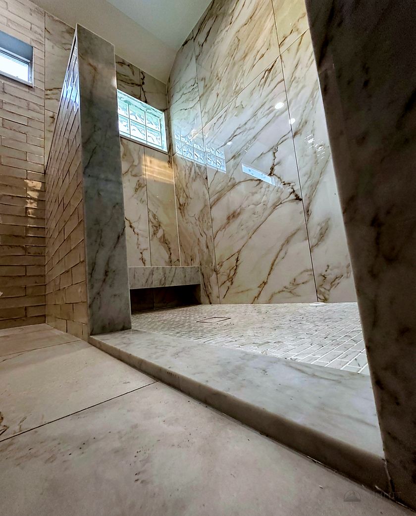 Shower walls clad in bookmatched marble